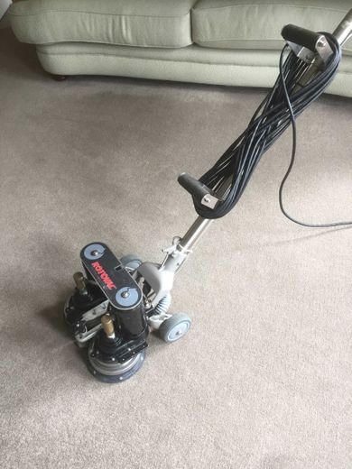 Machine cleaning a carpet